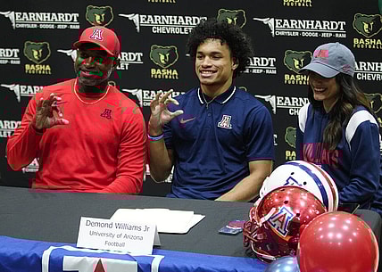 Basha quarterback Demond Williams poses for pictures after signing his letter of intent to play for University of Arizona during the NLI signing at Basha High School in Chandler on Dec. 20, 2023.