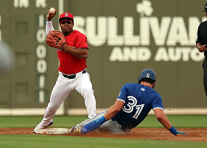 Mar 3, 2024; Fort Myers, Florida, USA; Boston Red Sox second baseman Enmanuel Valdez (47) forces out Toronto Blue Jays outfielder Cam Eden (31) and throws the ball to first base for a double play during the third inning at JetBlue Park at Fenway South. Mandatory Credit: Kim Klement Neitzel-USA TODAY Sports