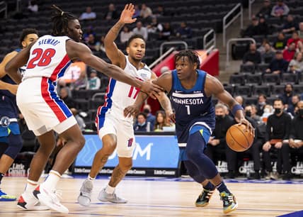 Feb 3, 2022; Detroit, Michigan, USA; Minnesota Timberwolves forward Anthony Edwards (1) gets defended by Detroit Pistons guard Rodney McGruder (17) and center Isaiah Stewart (28) during the first quarter at Little Caesars Arena. Mandatory Credit: Raj Mehta-USA TODAY Sports