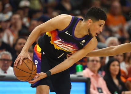 Apr 19, 2022; Phoenix, Arizona, USA; Phoenix Suns guard Devin Booker (1) against the New Orleans Pelicans during game two of the first round for the 2022 NBA playoffs at Footprint Center. Mandatory Credit: Mark J. Rebilas-USA TODAY Sports