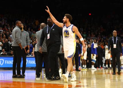 Oct 25, 2022; Phoenix, Arizona, USA; Golden State Warriors guard Klay Thompson waves at the Phoenix Suns bench after being ejected from the game in the second half at Footprint Center. Mandatory Credit: Mark J. Rebilas-USA TODAY Sports