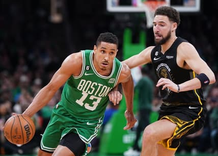 Jan 19, 2023; Boston, Massachusetts, USA; Boston Celtics guard Malcolm Brogdon (13) drive the ball against Golden State Warriors guard Klay Thompson (11) in the second half at TD Garden. Mandatory Credit: David Butler II-USA TODAY Sports