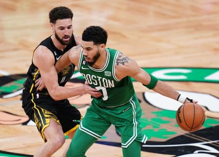 Jan 19, 2023; Boston, Massachusetts, USA; Boston Celtics forward Jayson Tatum (0) dribbles the ball against Golden State Warriors guard Klay Thompson (11) in the second quarter at TD Garden. Mandatory Credit: David Butler II-USA TODAY Sports