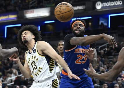 Apr 5, 2023; Indianapolis, Indiana, USA;  New York Knicks center Mitchell Robinson (23) knocks a rebound away from Indiana Pacers forward Jordan Nwora (13) during the first half at Gainbridge Fieldhouse. Mandatory Credit: Marc Lebryk-USA TODAY Sports