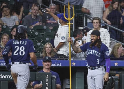 Jul 6, 2023; Houston, Texas, USA; Seattle Mariners shortstop J.P. Crawford (3) presents a trident to third baseman Eugenio Suarez (28) after Suarez hits a home run during the ninth inning against the Houston Astros at Minute Maid Park. Mandatory Credit: Troy Taormina-USA TODAY Sports