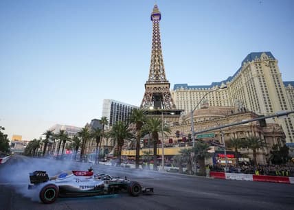 Nov 5, 2022; Las Vegas, Nevada, USA;  Mercedes-AMG Petronas driver George Russell spins his car on the track during the Formula One Las Vegas Grand Prix Launch Party at Las Vegas Strip. Mandatory Credit: Ray Acevedo-USA TODAY Sports