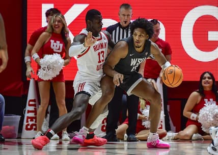 Dec 29, 2023; Salt Lake City, Utah, USA; Washington State Cougars forward Isaac Jones (13) dribbles around Utah Utes center Keba Keita (13) during the second half at the Jon M. Huntsman Center. Mandatory Credit: Christopher Creveling-USA TODAY Sports