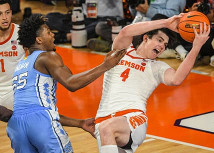 Jan 6, 2024; Clemson, South Carolina, USA; Clemson junior forward Ian Schieffelin (4) rebounds near University of North Carolina forward Harrison Ingram (55) during the first half at Littlejohn Coliseum. Mandatory Credit: Ken Ruinard-USA TODAY Sports