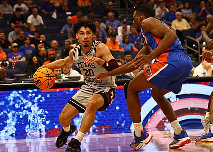 Mar 10, 2022; Tampa, FL, USA; Texas A&M Aggies guard Andre Gordon (20) drives to the basket as Florida Gators guard Phlandrous Fleming Jr. (24) defends during the first half at Amalie Arena. Mandatory Credit: Kim Klement-USA TODAY Sports