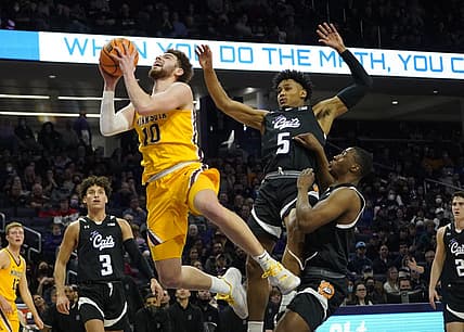 Mar 6, 2022; Evanston, Illinois, USA; Northwestern Wildcats guard Julian Roper II (5) defends Minnesota Golden Gophers forward Jamison Battle (10) during the first half at Welsh-Ryan Arena. Mandatory Credit: David Banks-USA TODAY Sports