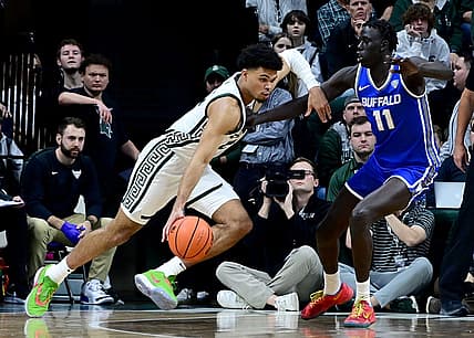 Dec 30, 2022; East Lansing, Michigan, USA; in his first game back from a foot injury Michigan State Spartans forward Malik Hall (25) drives against Buffalo Bulls forward Kuluel Mading (11) in the first half at Jack Breslin Student Events Center. Mandatory Credit: Dale Young-USA TODAY Sports