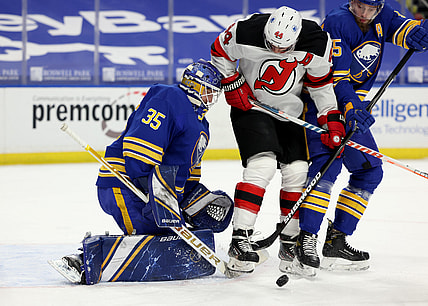 Apr 8, 2021; Buffalo, New York, USA; New Jersey Devils left wing Miles Wood (44) tries to deflect a shot on Buffalo Sabres goaltender Linus Ullmark (35) during the first period at KeyBank Center. Mandatory Credit: Timothy T. Ludwig-USA TODAY Sports