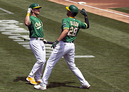 Apr 21, 2021; Oakland, California, USA; Oakland Athletics Matt Olson (28) gets an elbow bash from teammate Matt Chapman after hitting a solo home run against the Minnesota Twins during the second inning of a Major League Baseball game at RingCentral Coliseum. Mandatory Credit: D. Ross Cameron-USA TODAY Sports
