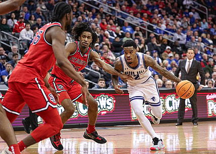 Jan 16, 2024; Newark, New Jersey, USA; Seton Hall Pirates guard Al-Amir Dawes (2) dribbles as St. John's Red Storm forward Glenn Taylor Jr. (35) and forward Drissa Traore (55) defend during the second half at Prudential Center. Mandatory Credit: Vincent Carchietta-USA TODAY Sports