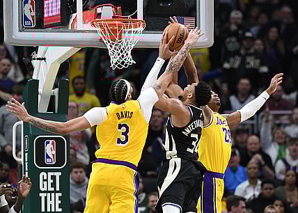 Mar 26, 2024; Milwaukee, Wisconsin, USA; Milwaukee Bucks forward Giannis Antetokounmpo (34) puts up a shot against Los Angeles Lakers forward Anthony Davis (3) and Los Angeles Lakers forward Rui Hachimura (28) in the second overtime at Fiserv Forum. Mandatory Credit: Michael McLoone-USA TODAY Sports
