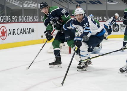 Feb 19, 2021; Vancouver, British Columbia, CAN; Winnipeg Jets forward Mark Scheifele (55) checks Vancouver Canucks forward Adam Gaudette (96) in the second period at Rogers Arena. Mandatory Credit: Bob Frid-USA TODAY Sports