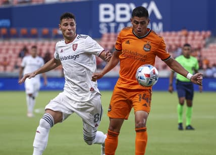 Jul 31, 2021; Houston, Texas, USA; Real Salt Lake midfielder Damir Kreilach (8) and Houston Dynamo FC midfielder Joe Corona (14) battle for the ball during the first half at BBVA Stadium. Mandatory Credit: Troy Taormina-USA TODAY Sports