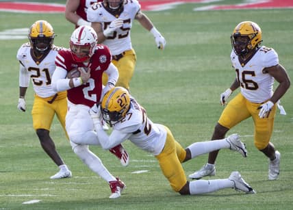 Dec 12, 2020; Lincoln, Nebraska, USA; Nebraska Cornhuskers quarterback Adrian Martinez (2) is tackled by Minnesota Golden Gophers defensive back Tyler Nubin (27) during the third quarter at Memorial Stadium. Mandatory Credit: Dylan Widger-USA TODAY Sports