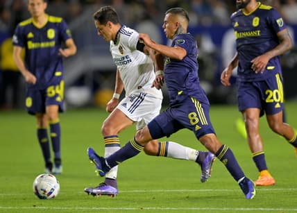 Apr 23, 2022; Carson, California, USA; Los Angeles Galaxy forward Javier Hernandez (14) and Nashville SC midfielder Randall Leal (8) battle for the ball in the second half at Dignity Health Sports Park. Mandatory Credit: Jayne Kamin-Oncea-USA TODAY Sports