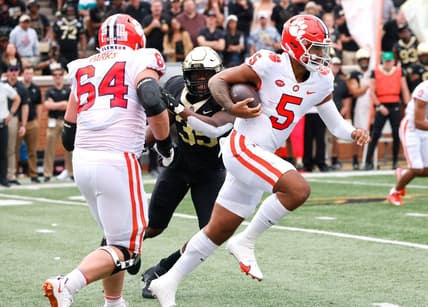Sep 24, 2022; Winston-Salem, North Carolina, USA;  Clemson Tigers quarterback DJ Uiagalelei (5) runs the ball between  offensive lineman Walker Parks (64) and Wake Forest Demon Deacons defensive lineman Kendron Wayman (35) during the second quarter at Truist Field. Mandatory Credit: Reinhold Matay-USA TODAY Sports