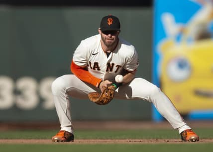 Oct 2, 2022; San Francisco, California, USA; San Francisco Giants third baseman Evan Longoria (10) cannot handle a sharp grounder by Arizona Diamondbacks first baseman Christian Walker during the tenth inning at Oracle Park. Mandatory Credit: D. Ross Cameron-USA TODAY Sports