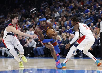 Jan 6, 2023; Oklahoma City, Oklahoma, USA; Oklahoma City Thunder guard Shai Gilgeous-Alexander (2) drives between Washington Wizards forward Deni Avdija (9) and guard Delon Wright (55) during the first quarter at Paycom Center. Mandatory Credit: Alonzo Adams-USA TODAY Sports