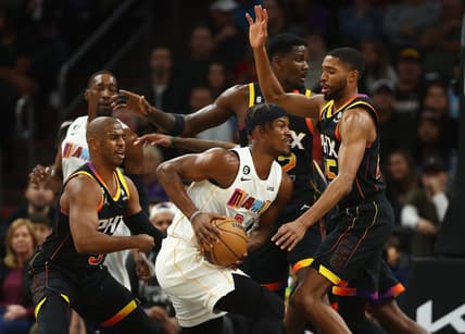 Jan 6, 2023; Phoenix, Arizona, USA; Phoenix Suns guard Chris Paul (left) and forward Mikal Bridges (right) defend against Miami Heat forward Jimmy Butler (center) in the first half at Footprint Center. Mandatory Credit: Mark J. Rebilas-USA TODAY Sports