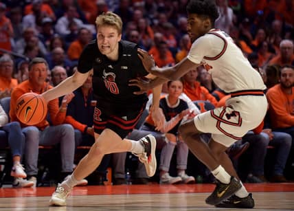 Feb 11, 2023; Champaign, Illinois, USA;  Rutgers Scarlet Knights guard Cam Spencer (10) drives the ball as Illinois Fighting Illini guard Sencire Harris (1) defends during the second half at State Farm Center. Mandatory Credit: Ron Johnson-USA TODAY Sports