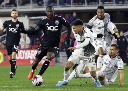 Feb 25, 2023; Washington, District of Columbia, USA;  D.C. United forward Christian Benteke (20) and Toronto FC defender Raoul Petretta (28) battle for the ball during the second half at Audi Field. Mandatory Credit: Geoff Burke-USA TODAY Sports