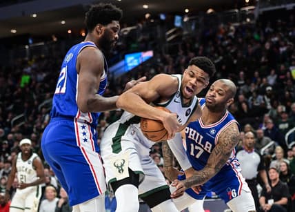 Apr 2, 2023; Milwaukee, Wisconsin, USA; Milwaukee Bucks forward Giannis Antetokounmpo (34) fights for the ball against Philadelphia 76ers forward P.J. Tucker (17) and forward Joel Embiid (21) during the first quarter at Fiserv Forum. Mandatory Credit: Benny Sieu-USA TODAY Sports