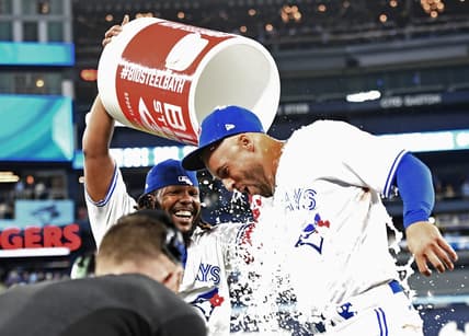 Apr 12, 2023; Toronto, Ontario, CAN;  Toronto Blue Jays right fielder George Springer (4) is doused with ice water by first baseman Vladimir Guerrero Jr. (27) after hitting a walkoff RBI single against the Detroit Tigers in the 10th  inning at Rogers Centre. Mandatory Credit: Dan Hamilton-USA TODAY Sports