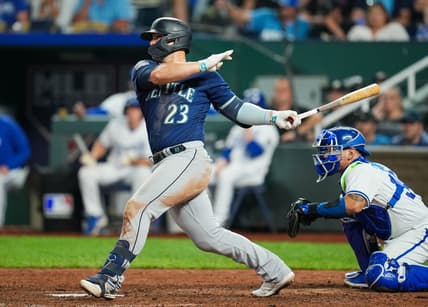 Aug 15, 2023; Kansas City, Missouri, USA; Seattle Mariners first baseman Ty France (23) hits a two-run single against the Kansas City Royals during the tenth inning at Kauffman Stadium. Mandatory Credit: Jay Biggerstaff-USA TODAY Sports