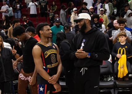 Mar 28, 2023; Houston, TX, USA; West guard Bronny James (6) with father LeBron James following the McDonald's All American Boy's high school basketball game at Toyota Center. Mandatory Credit: Mark J. Rebilas-USA TODAY Sports