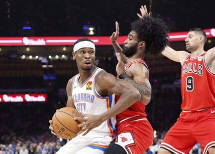 Nov 22, 2023; Oklahoma City, Oklahoma, USA; Oklahoma City Thunder guard Shai Gilgeous-Alexander (2) is defended by Chicago Bulls guard Coby White (0) on a drive to the basket during the second quarter at Paycom Center. Mandatory Credit: Alonzo Adams-USA TODAY Sports