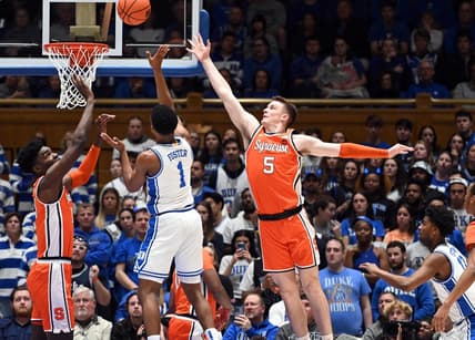 Jan 2, 2024; Durham, North Carolina, USA; Duke Blue Devils guard Caleb Foster (1) shoots between Syracuse Orange guard Justin Taylor (5) and center Naheem McLeod (10) during the first half at Cameron Indoor Stadium. Mandatory Credit: Rob Kinnan-USA TODAY Sports