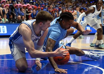 Mar 9, 2024; Durham, North Carolina, USA; North Carolina Tar Heels forward Armando Bacot (5) grabs a loose ball from Duke Blue Devils center Kyle Filipowski (30) during the first half at Cameron Indoor Stadium. Mandatory Credit: Rob Kinnan-USA TODAY Sports