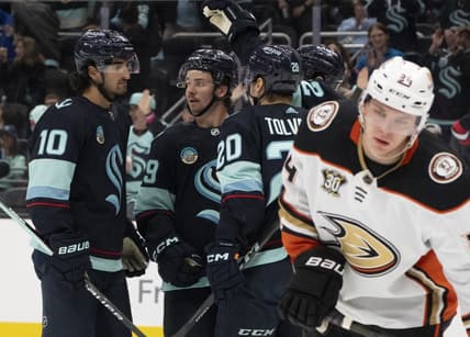 Mar 26, 2024; Seattle, Washington, USA; sSeattle Kraken players icnlduing forward Matty Beniers (10), forward Logan Morrison (59), second from left, and forward Eeli Tolvanen (20) celebrate a goald during the second period against the Anaheim Ducks gat Climate Pledge Arena. Mandatory Credit: Stephen Brashear-USA TODAY Sports