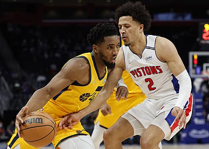 Jan 10, 2022; Detroit, Michigan, USA;  Utah Jazz guard Donovan Mitchell (45) dribbles defended by Detroit Pistons guard Cade Cunningham (2) in the second half at Little Caesars Arena. Mandatory Credit: Rick Osentoski-USA TODAY Sports