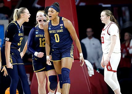 Notre Dame's Sam Brunelle (33), Abby Prohaska (12) and Maya Dodson (0) celebrate next to Oklahoma's Taylor Robertson (30) in the first half of a 108-64 win Monday in the second round of the NCAA Tournament at Lloyd Noble Center in Norman.

COVER MAIN
