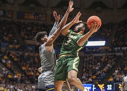 Dec 10, 2022; Morgantown, West Virginia, USA; UAB Blazers guard Tavin Lovan (3) shoots the ball against West Virginia Mountaineers forward Mohamed Wague (11) during the first half at WVU Coliseum. Mandatory Credit: Ben Queen-USA TODAY Sports