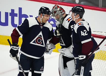 Nov 1, 2023; Denver, Colorado, USA; Colorado Avalanche goaltender Ivan Prosvetov (50) and defenseman Jack Johnson (3) and defenseman Josh Manson (42) celebrate the win over the St. Louis Blues in the second period at Ball Arena. Mandatory Credit: Ron Chenoy-USA TODAY Sports
