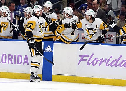Nov 30, 2023; Tampa, Florida, USA; Pittsburgh Penguins center Jeff Carter (77) is congratulated after he scored a goal against the Tampa Bay Lightning during the third period at Amalie Arena. Mandatory Credit: Kim Klement Neitzel-USA TODAY Sports