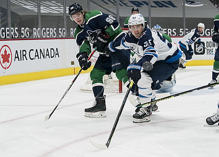 Feb 19, 2021; Vancouver, British Columbia, CAN; Winnipeg Jets forward Mark Scheifele (55) checks Vancouver Canucks forward Adam Gaudette (96) in the second period at Rogers Arena. Mandatory Credit: Bob Frid-USA TODAY Sports