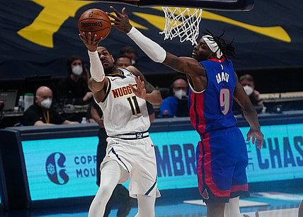 Apr 6, 2021; Denver, Colorado, USA; Detroit Pistons forward Jerami Grant (9) tips the ball from Denver Nuggets guard Monte Morris (11) in the first quarter at Ball Arena. Mandatory Credit: Ron Chenoy-USA TODAY Sports