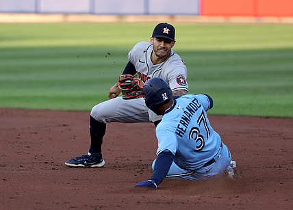 Jun 4, 2021; Buffalo, New York, USA;  Houston Astros shortstop Carlos Correa (1) tags out Toronto Blue Jays right fielder Teoscar Hernandez (37) as he tries to steal second base during the second inning at Sahlen Field. Mandatory Credit: Timothy T. Ludwig-USA TODAY Sports