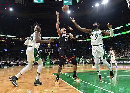 Nov 22, 2021; Boston, Massachusetts, USA;  Houston Rockets center Daniel Theis (27) and Boston Celtics guard Jaylen Brown (7) battle for a rebound while center Robert Williams III (44) looks on during the first half at TD Garden. Mandatory Credit: Bob DeChiara-USA TODAY Sports