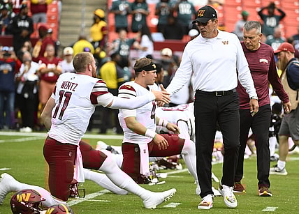 Sep 25, 2022; Landover, Maryland, USA; Washington Commanders head coach Ron Rivera greets quarterback Carson Wentz (11) before the game between the Washington Commanders and the Philadelphia Eagles at FedExField. Mandatory Credit: Brad Mills-USA TODAY Sports