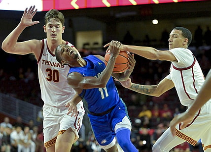 Nov 7, 2022; Los Angeles, California, USA; Florida Gulf Coast Eagles guard Isaiah Thompson (11) is defended by USC Trojans forward Harrison Hornery (30) and forward Kobe Johnson (0) as he drives to the basket in the second half at Galen Center. Mandatory Credit: Jayne Kamin-Oncea-USA TODAY Sports