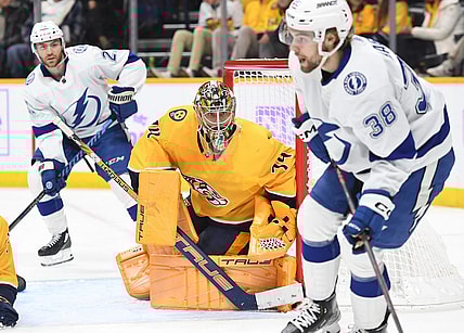 Nov 19, 2022; Nashville, Tennessee, USA; Nashville Predators goaltender Juuse Saros (74) watches as Tampa Bay Lightning left wing Brandon Hagel (38) handles the puck during the second period at Bridgestone Arena. Mandatory Credit: Christopher Hanewinckel-USA TODAY Sports