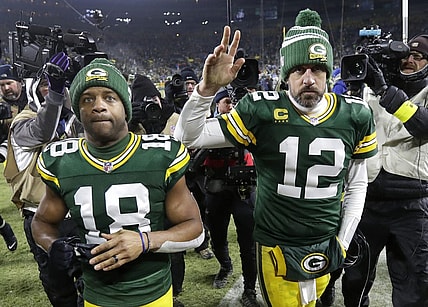 Jan 8, 2023; Green Bay, Wisconsin, USA; Green Bay Packers wide receiver Randall Cobb (18) and quarterback Aaron Rodgers (12) leave the field together after losing to the Detroit Lions at Lambeau Field. Mandatory Credit: Dan Powers/Appleton Post-Crescent via USA TODAY NETWORK